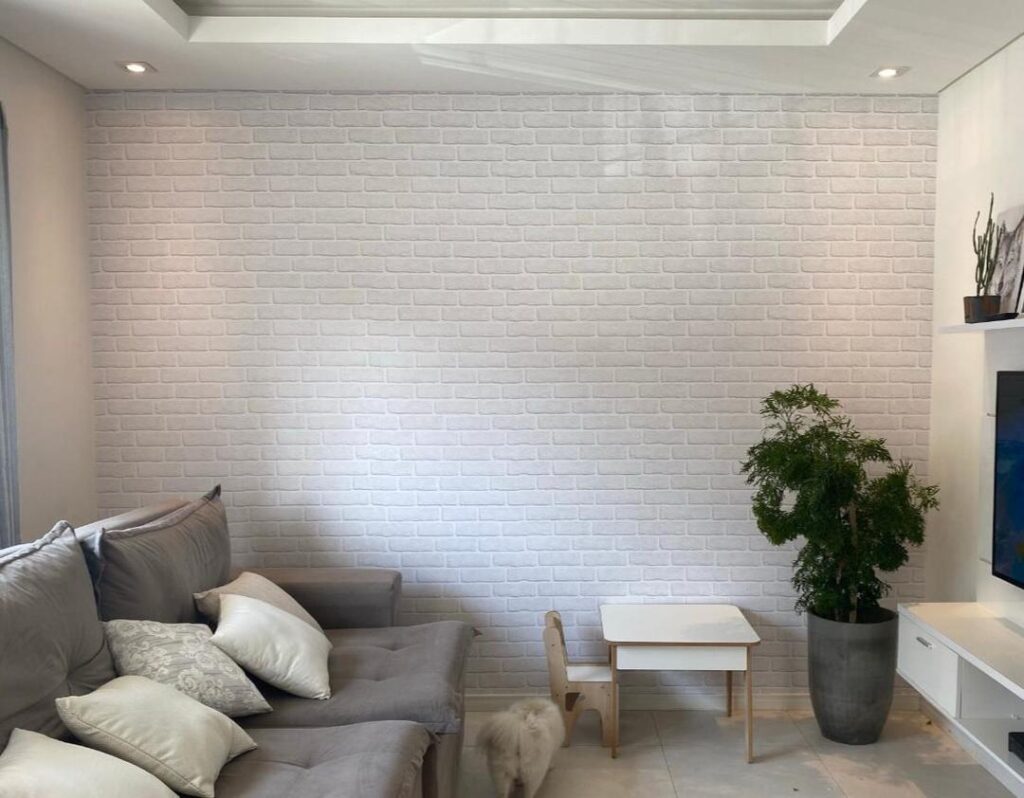 Papel De Parede Adesivo Autocolante Tijolo Rústico Branco aplicado na parede de destaque, em uma sala de estar. 